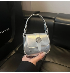 Close-up of silver mini square bag featuring a vintage embossed C letter metal buckle