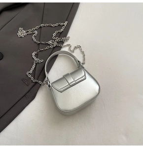 Detail of silver mini square bag with metallic leather texture and chain strap