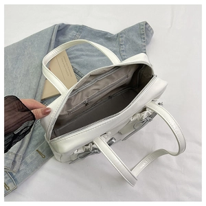Close-up of the spacious main compartment and interior zipper pocket of the white tote bag