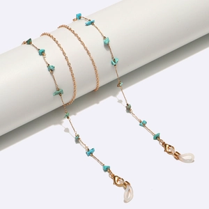 Detail of gold chain eyewear strap featuring irregular turquoise beads and rubber grips