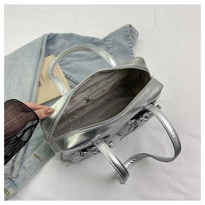 Detail view of large silver tote bag interior showing spacious main compartment and zipper pocket