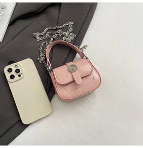 Pink mini crossbody bag size comparison with smartphone showing the micro square design