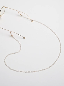 Detail of gold chain for glasses with square crystal beads and silicone non-slip loops