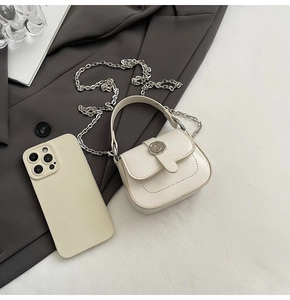 Macro view showing cream leather texture and silver C buckle detail on mini square bag
