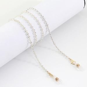 Close-up of square crystal beads and golden lobster clasp on a sunglasses chain