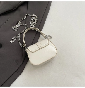 Detail of off-white mini square bag with glossy patent leather and silver chain strap