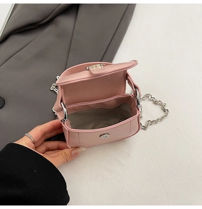 Detailed view of pink mini chain bag with magnetic clasp and silver metallic hardware