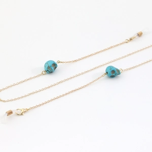 Golden eyewear chain with turquoise skull charms and adjustable silicone loops