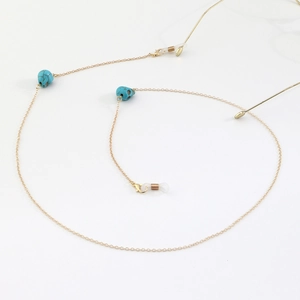 Gold metal eyewear chain featuring turquoise skull beads and non-slip silicone loops