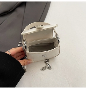 Internal view of a white mini leather bag showing lining and magnetic closure
