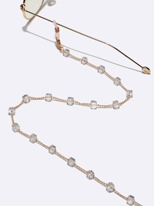 Detail of gold eyewear chain with clear square crystals and silicone anti-slip loops