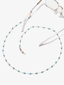 Detail of gold chain eyewear strap with blue turquoise beads and anti-slip silicone loops