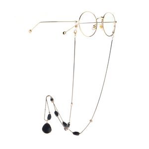 Golden round frame glasses with elegant black beaded chain on a clean white background