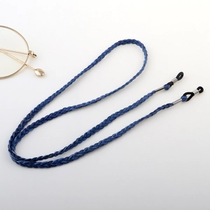 Detail of dark blue braided eyeglass strap with adjustable loops and metal fasteners