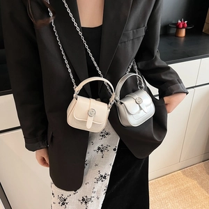 Mini crossbody saddle bags in ivory and silver with sleek chain strap and round lock