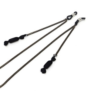 Minimalist black eyewear chain with decorative candy pendants and adjustable rubber loops