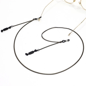 Fashionable black and gold metal eyewear chain with stylish candy-shaped pendants