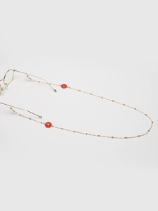 Close-up of golden eyewear chain featuring red daisy charms and anti-slip silicone loops