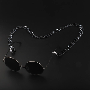 Macro view of thick black acrylic glasses chain links with clear rubber connectors