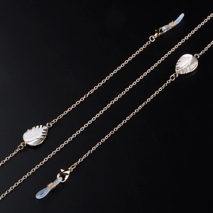 Handmade golden eyewear chain with white shell leaf charms and adjustable silicone loops