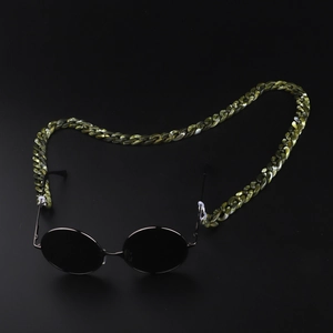 Close-up of green marble acrylic eyewear chain with round black sunglasses detail