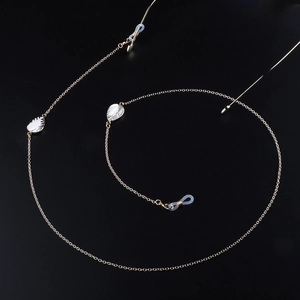 Minimalist gold glasses chain with white leaf pendants and transparent rubber loops