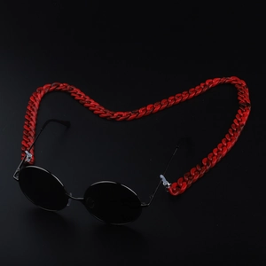 Retro round sunglasses with red marble acrylic chain strap on a black background