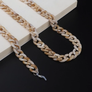 Detail of tortoiseshell acrylic glasses chain with marble texture and silver metal loops