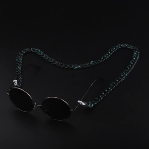 Retro round black sunglasses with chunky dark green acrylic chain strap on black background