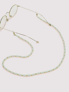 Detail of white pearl glasses chain with gold beads and non-slip silicone loops