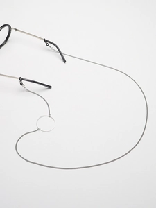 Close-up of silver stainless steel eyewear chain with hollow ring detail and rubber grips