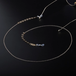 Minimalist gold metal eyeglass chain with decorative leaf charms and silicone loops