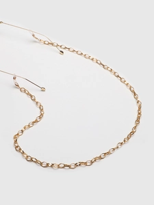 Detail of gold oval link eyewear chain showing metal texture and silicone end loops