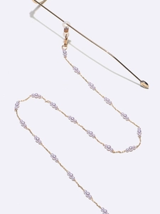 Detail of lavender pearl eyeglass chain with gold metal links and adjustable loops