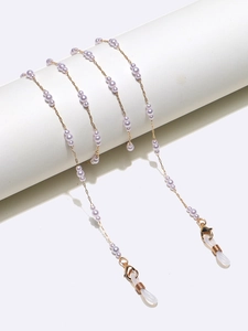 Elegant gold metal eyewear chain featuring small purple pearls and silicone loops