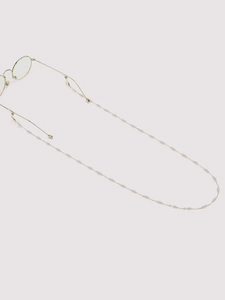 Elegant gold glasses chain with white pearls attached to thin wire frames