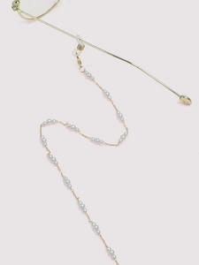 Detail of gold pearl eyewear chain with silicone ends attached to glasses frames