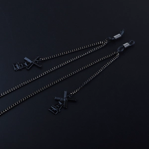 Sleek matte black eyewear chain featuring minimalist windmill charms and silicone loops