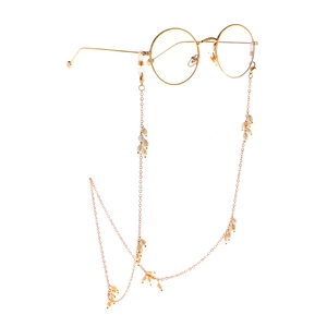 Lunettes rondes dorées avec chaîne en perles d'eau douce irrégulières sur fond blanc