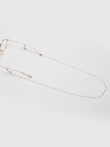 Close-up of gold chain eyewear strap with transparent crystals and silicone loops