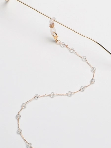 Detail of gold chain with transparent crystal beads and silicone non-slip eyeglass loops