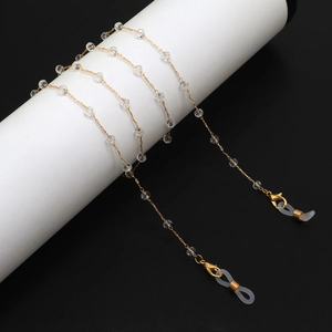 Elegant gold-plated eyewear chain featuring faceted clear crystal beads and silicone loops