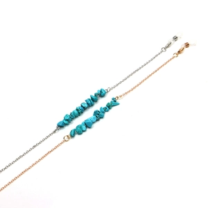 Detail of gold and silver eyeglass chains with natural blue turquoise stone beads
