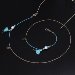 Detail of blue tassels and ceramic beads on a multi-element handmade glasses chain