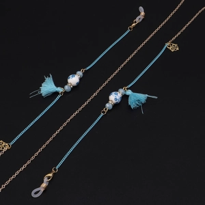 Detail of blue tassels and blue porcelain beads on a stylish glasses chain strap