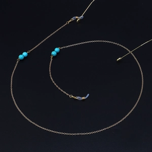 Elegant gold metal glasses chain featuring turquoise beads and non-slip silicone loops