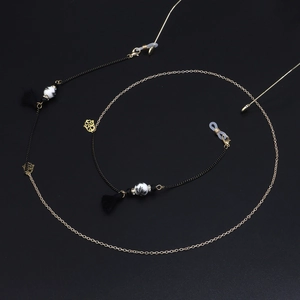Detail of colorful ceramic beads and black tassels on a stylish eyewear chain