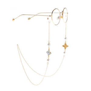 Golden metal eyewear chain with white pearls and flower pendants on glasses