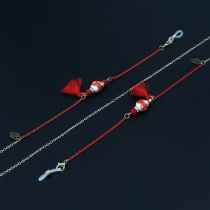 Red braided cord eyewear chain with ceramic floral beads and silk tassels on black background