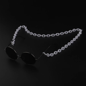 Detail of round sunglasses with a translucent white acrylic thick link chain accessory